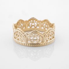 a gold ring with intricate designs on it