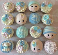 twelve cupcakes decorated in pastel blue and white frosting with teddy bears on them