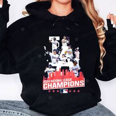 a woman wearing a black hoodie with the number 15 on it and an image of baseball players