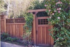 a wooden gate surrounded by greenery and flowers