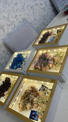 four framed pictures with flowers in them on display