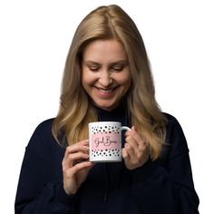 a woman holding a coffee mug with the words girl on it