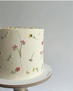 there is a white cake with flowers on it