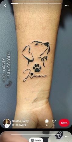 a dog's paw and name tattoo on the wrist