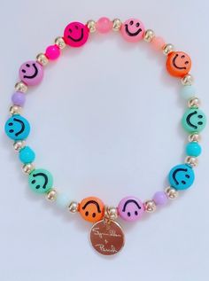 "This bracelet is handmade with love using some of our newest smiley face beads. **Please note the shipping time. This specific bracelet is a pre order, which means it will take anywhere between 1 to 2 weeks to arrive. To ensure a proper size, use a tape measure around your wrist. Place a dot where the tape measure meets. That is your wrist size! In our drop down menu, we have also included the average sizes for you. Please note we are not responsible if bracelet does not fit after providing thi Smiley Face Round Beads Bracelet For Gift, Trendy Stretch Bracelet With Smiley Face Round Beads, Trendy Smiley Face Stretch Bracelet With Round Beads, Smiley Face Round Beads Bracelet As Gift, Casual Adjustable Smiley Face Bracelets, Casual Adjustable Smiley Face Bracelet, Playful Stretch Bracelet With Smiley Face For Gift, Adjustable Smiley Face Bracelets As Gift, Adjustable Smiley Face Bracelet As Gift