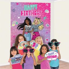 a group of girls standing next to each other in front of a happy birthday sign