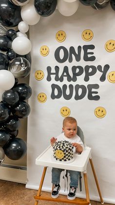 a baby sitting in a high chair with balloons around him and the words one happy dude on it