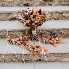 an arrangement of dried flowers on the steps