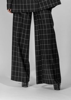 Black checkered pants made from 100% wool. The pants length is to the ground. The fit is tight in the waist with wide leg cut.rnrnThe pants are to be worn at waist height and is closed by a zipper in the side seem. The complete piece is lined with lining.rnrnALL OUR PIECES ARE MADE-TO-ORDER. Please read our policy. Black Checkered Pants, Waste Fashion, Graphic Jackets, Zero Waste Fashion, Checkered Pants, Black Checkered, Wool Pants, Zipper Jacket, Pants Length