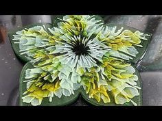 a green and yellow flower sitting on top of a car seat cover in the rain