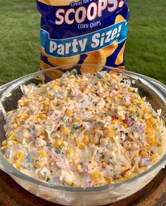 a bowl of party size corn salad next to a bag of scoops