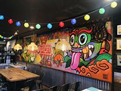 a colorful mural on the wall of a restaurant