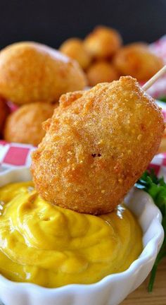 fried food with dipping sauce on it and other foods in the backgroung