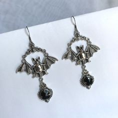 These large gothic vampire inspired earrings are made with antiqued silver plated bats, filigrees and stainless steel earring hooks,  accented with sparkling glass crystals in JET BLACK ONYX. Earrings measure 3 1/2" tall and are 1 7/8" wide.Matching necklace is available in our shop. If you would like these in a different stone color, please send us a message. Vampire Style Metal Earrings For Halloween, Halloween Vampire Metal Earrings, Vampire Style Metal Pierced Earrings, Halloween Oxidized Metal Jewelry, Halloween Metal Jewelry With Oxidized Finish, Gothic Silver Metal Earrings, Silver Gothic Metal Earrings, Gothic Halloween Jewelry With Oxidized Finish, Gothic Oxidized Jewelry For Halloween