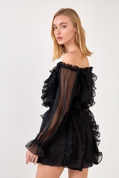 This black off the shoulder romper is perfect for any cocktail events! The ruffled detailing adds a fun and flirty touch, while the loose fit makes it comfortable to wear. Plus, the romper has pockets so you can keep your essentials close by. Pair it with sandals or heels for an elegant look. Off the shoulder Chiffon Ruffle detail Lined Elastic on the waist Shell: 100% Polyester Lining : 100 % Polyester Style# JJ907P Size on Model: S Model Measurements:Height 5'10" / (178cm) / Bust 33" / (84cm) Chic One Shoulder Ruffled Jumpsuit, Chic One-shoulder Ruffled Jumpsuit, Flirty Off-shoulder Jumpsuits And Rompers With Ruffles, Casual Off-shoulder Jumpsuits And Rompers For Party, Casual Off-shoulder Jumpsuit For Party, Elegant Ruffled Jumpsuits And Rompers For Date Night, Spring Party Off-shoulder Jumpsuits And Rompers, Flirty Ruffle Hem Jumpsuits And Rompers For Party, Flirty Party Jumpsuits With Ruffle Hem