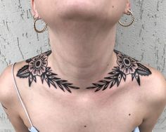 a woman with a black and white tattoo on her neck