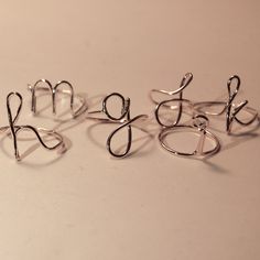 "initial ring - b initial ring - minimalist ring - personalized initial - bridesmaids - initial wire ring - silver initial ring - custom ringA tiny delicate cute little initial ring. Shown \"a,b,d,e,h,m,g,j,k i\" can make any initial you desire. Can make any letter lower case only for this add. Adorable flower girl gift or perfect mid knuckle ring. Comes in a little white organza bag. Please indicate what initial at checkout in note to seller. Thank you! Enter my shop: https://www.etsy.com/shop/ Minimalist Hypoallergenic Silver Initial Ring, Cheap Adjustable Initial Ring, Silver Adjustable Initial Ring Gift, Minimalist Adjustable Initial Ring, Hypoallergenic, Letter Rings Initial Wire, Silver Initial Ring, Knuckle Rings, Flower Girl Gifts, Initial Ring