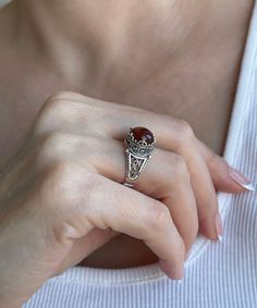 This everyday use, lace embroidery minimalist 925 sterling silver filigree art crown cocktail ring has natural Carnelian gemstone. This stunning sterling silver ring is a modern take on the classic crown. The ring face is 0.47 of an inch (12 mm) and comes with a carnelian gemstone that's 10 mm long and has been faceted to a cabochon round-cut to enhance the stone's beauty. This versatile piece looks great with both day and evening attire and features a smooth oxidized finish, ensuring lasting be Elegant Carnelian Rings For Wedding, Cabochon Filigree Ring Gift, Gift Filigree Ring With Cabochon, Elegant Silver Carnelian Ring, Elegant Carnelian Jewelry Stamped 925, Classic Silver Carnelian Jewelry, Filigree Rings, Art Crown, The Ring Face