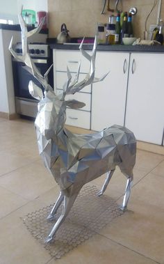 a metal sculpture of a deer in a kitchen