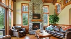 a living room filled with furniture and a fire place in the middle of a room