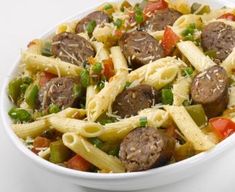 a white bowl filled with pasta and meatballs