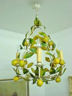 a chandelier with lemons and leaves hanging from it