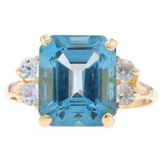 Size: 9 1/2 Sizing Fee: Up 3 sizes for $40 or Down 3 sizes for $30 Metal Content: 14k Yellow Gold Stone Information Natural Topaz Treatment: Routinely Enhanced Carat(s): 7.21ct Cut: Emerald Color: Blue Natural Sapphires Treatment: Heating Carat(s): .60ctw Cut: Round Color: White Total Carats: 7.81ctw Style: Solitaire with Accents Measurements Face Height (north to south): 1/2" (12.1mm) Rise Above Finger: 5/16" (7.2mm) Weight: 4.7 Grams Stamps: 14k Condition: Pre-Owned Professionally cleaned, polished, and tested to guarantee metal content. Wilson Brothers, Sapphire Halo Ring, Topaz Yellow, Vintage Gold Earrings, Gold Topaz, White Sapphire Ring, White Gold Sapphire, Blue Topaz Stone, Emerald Color