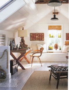 a living room filled with furniture and decor on top of a wooden floor covered in white walls