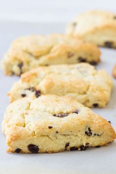 chocolate chip cookies sitting on top of a piece of parchment paper