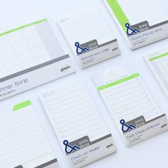 several notepads with stickers on them sitting next to each other in front of a white background