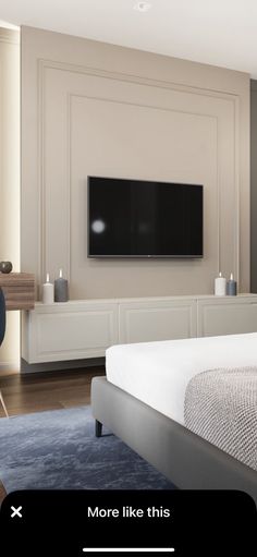 a bedroom with a large bed and a flat screen tv mounted on the wall above it