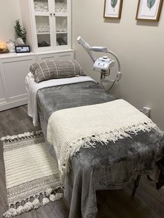 a bed with a blanket on top of it in a room