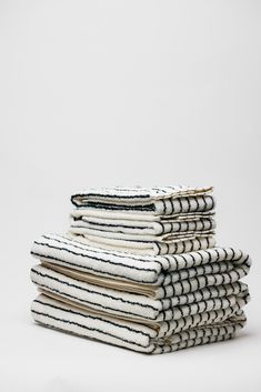 stack of black and white towels on top of each other