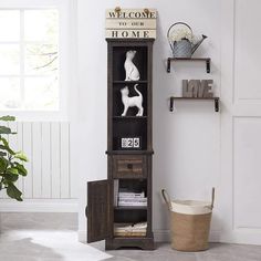 a wooden shelf with books and figurines on it next to a potted plant