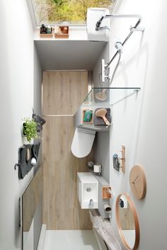 a small bathroom with a skylight above the toilet and sink area is shown in this image