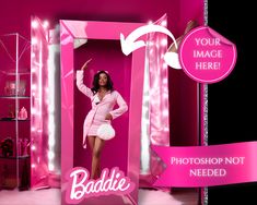 a woman is posing in a pink photo booth