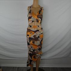 Turn Every Head In The Room With This Racy, Flirty, Fun Dress! Beautiful Brown, Tan, Beige, Orange, And Black Abstract Print, Low Back, Halter Neck, Cut Out Midriff, Crisscross Bust, And Ruched Asymmetrical Skirt Give This Piece Plenty To Go On About. Brand New With Tag. Can't Measure Due To The Nature Of This Piece, See Brand's Website For Measurements. Please See Photos For Exact Condition. Bundle 2 Or More Items From My Closet To Receive A Great Discount! Tub Da Orange Ruched Mini Dress With Stretch, Flirty Ruched Orange Dress, Flirty Orange Ruched Dress, Orange Ruched Midi Dress For Party, Stretch Orange Midi Dress For Night Out, Orange Halter Neck Midi Dress For Party, Orange Stretch Midi Dress For Beach, Bra Top Dress, Bronze Dress