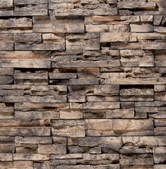 a stone wall that has been made out of different types of rocks and is brown