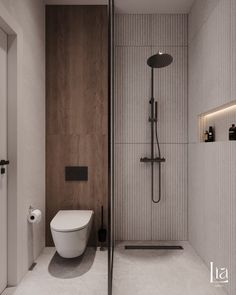 a bathroom with a toilet, shower head and wall mounted faucet in it