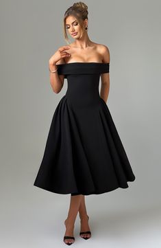 The elegant Miranda midi is made for those chic evenings, date nights and beyond. Cut from luxe stretch crepe, this style cinches at the waist with a sleek pleated Bardot neckline. The look is complete with voluminous panels to each side, and tulle in the skirt for a full look. Partner with soft glam and waves.Â 



Colour: Black.

Premium stretch crepe fabric.

Fully lined.

Bardot neckline with pleat detail.

Voluminous panels to each side.

Tulle in skirt for volume.

Full, dropped waist skir Homecoming Dresses Corset, Midi Dress Wedding Guest, Drop Waist Skirt, Bardot Neckline, Maxi Dress Sale, Soft Glam, Date Nights, Sparkle Dress, Strapless Maxi Dress