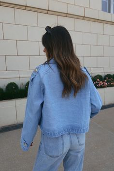 DETAILS: Our Cropped Denim Trench Jacket is a cropped light wash denim jacket with the cutest oversized fit. This collared denim jacket features a tortoise button details throughout ,adjustable belted waistline, functional pockets, and belted sleeve detail. The trench style silouette is what gives this jacket a truly unique look. This jacket is completed with a relaxed and comfortable fit. This jacket has little to no stretch and runs true to size. CONTENT & CARE: SELF: 100% Cotton. SIZE & FIT: Trendy Light Wash Button-up Outerwear, Casual Washed Blue Denim Jacket For Day Out, Casual Button-up Cropped Jacket For Summer, Spring Denim Cropped Jacket With Button Closure, Trendy Cropped Denim Jacket For Day Out, Trendy Relaxed Fit Denim Jacket With Buttons, Casual Button-up Cropped Jacket For Streetwear, Spring Button-up Cropped Denim Jacket, Cropped Denim Jacket With Pockets