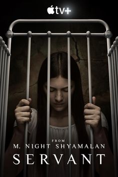 the poster for night shyman's servants shows a girl in jail with her hands behind bars