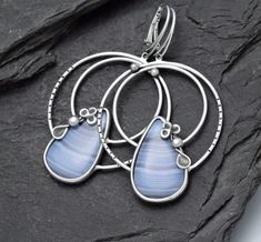 handmade earrings with Chalcedony natural Chalcedony big earrings with Chalcedony big, but not heavy patinated, polished material: silver Chalcedony from Namibia size of the earrings: 65 x 38,50 mm (2,567 × 1,522 inch) size of Chalcedony: 2,60 x 1,60 mm (1,028 x 0,635 inch) Handmade Chalcedony Earrings As Gift, Handmade Chalcedony Earrings For Gifts, Silver Agate Earrings With Natural Stones, Unique Silver Agate Earrings, Silver Agate Gemstone Earrings, Handmade Chalcedony Drop Earrings, Handmade Teardrop Agate Earrings, Nickel-free Silver Agate Earrings, Elegant Handmade Chalcedony Earrings