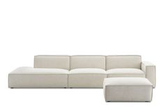 a white couch and footstool sitting next to each other on a white background