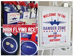 a party in a box with an airplane sign and other items to be used as decorations