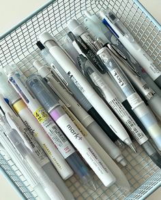 a basket filled with lots of different types of pens