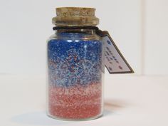 a glass jar filled with red, white and blue confetti sprinkles