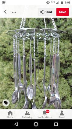 three spoons hanging from a metal rack with chains