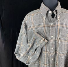 Fabulous vintage Donegal Estate tweed shirt in size XL. This is the shirt for someone allergic to wool. This is made is 50% polyester and 50% acrylic so easy to wash and  just hang up to dry. Beautiful Prince of Wales tweed in black and off white with a gold band.  Size XL Chest: 52" Around the hem: 56" Length: 29" Sleeves: 25" Back of neck to cuff: 36" Collar: 17-17.5 Shoulder back: 24" Excellent condition no issues. This could be a great sweater when it's cold or a great gift. Sale supports Vermont's Puppetree. Thank you & please check our Etsy  Support Store. Classic Wool Shirt For Fall, Plaid Wool Long Sleeve Shirt, Plaid Wool Shirt For Fall, Fall Plaid Wool Shirt, Casual Plaid Wool Top, Classic Wool Flannel Shirt For Winter, Casual Wool Collared Shirt, Classic Plaid Wool Flannel Shirt, Classic Wool Plaid Flannel Shirt