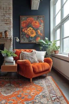 an orange couch sitting in front of a window next to a rug and potted plants